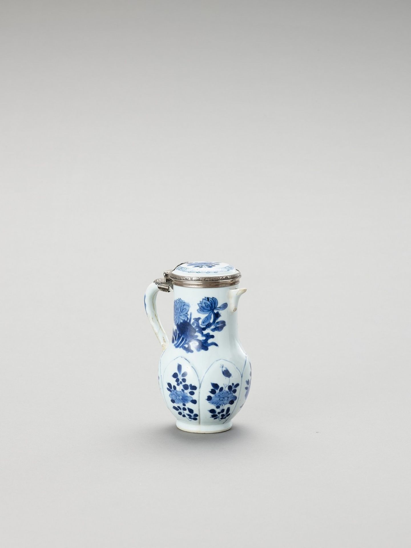 A SILVER-MOUNTED BLUE AND WHITE PORCELAIN JUG