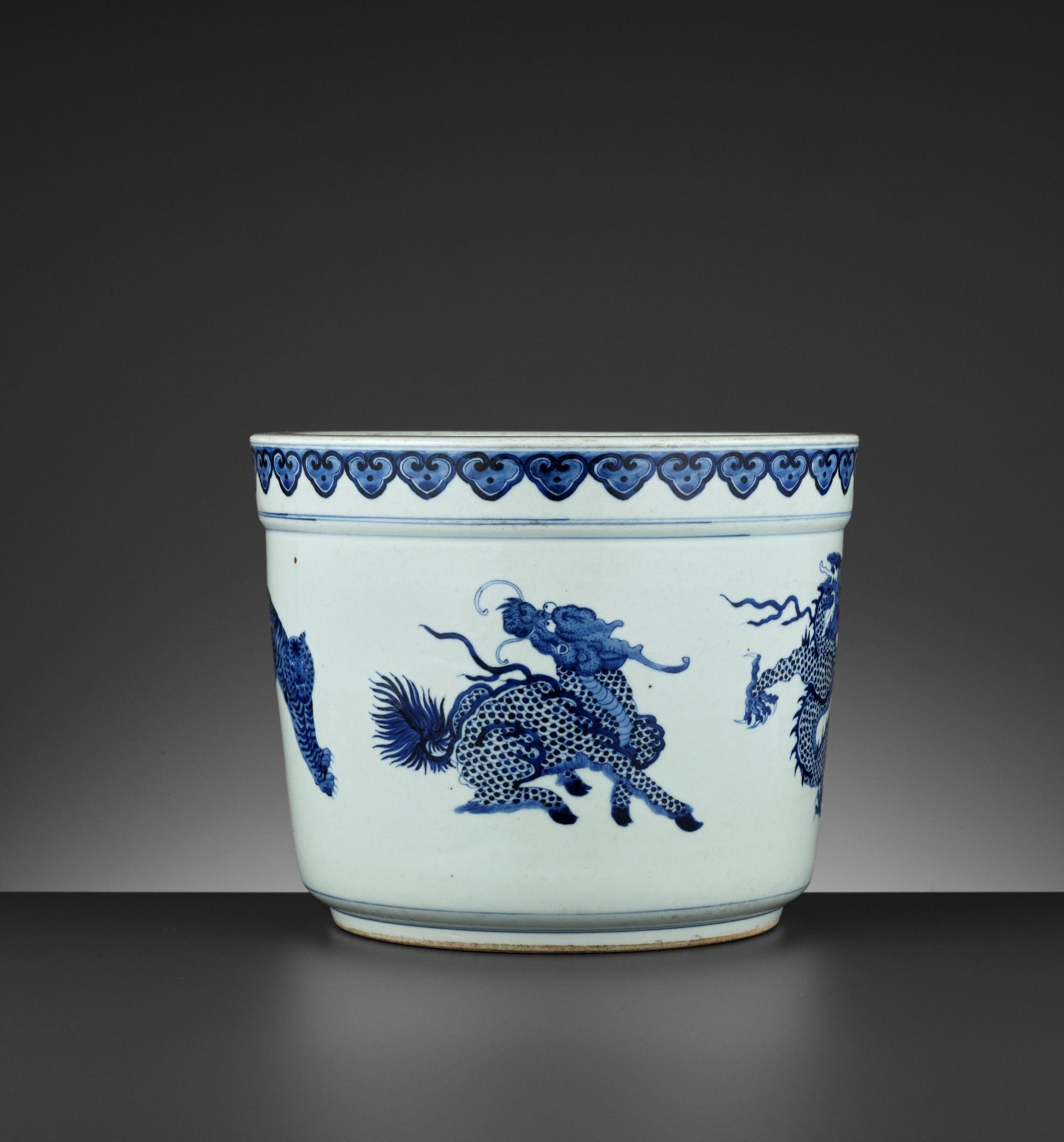 A MASSIVE BLUE AND WHITE 'FIVE MYTHICAL BEASTS' JARDINIERE, QING DYNASTY