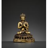 A GILT BRONZE FIGURE OF A CROWNED BUDDHA, DATED 1709
