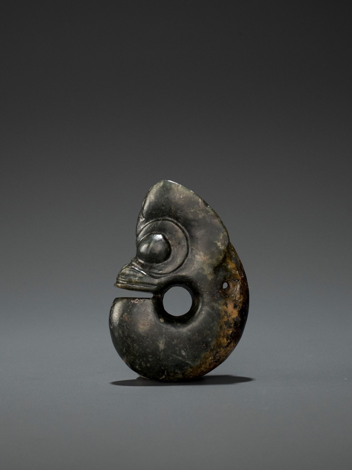 A DARK-GREEN JADE 'PIG-DRAGON' CARVING, ZHULONG, HONGSHAN CULTURE, C. 4000-3000 BC