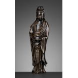 A MASSIVE SILVER-INLAID SHISOU BRONZE FIGURE OF GUANYIN, QING DYNASTY