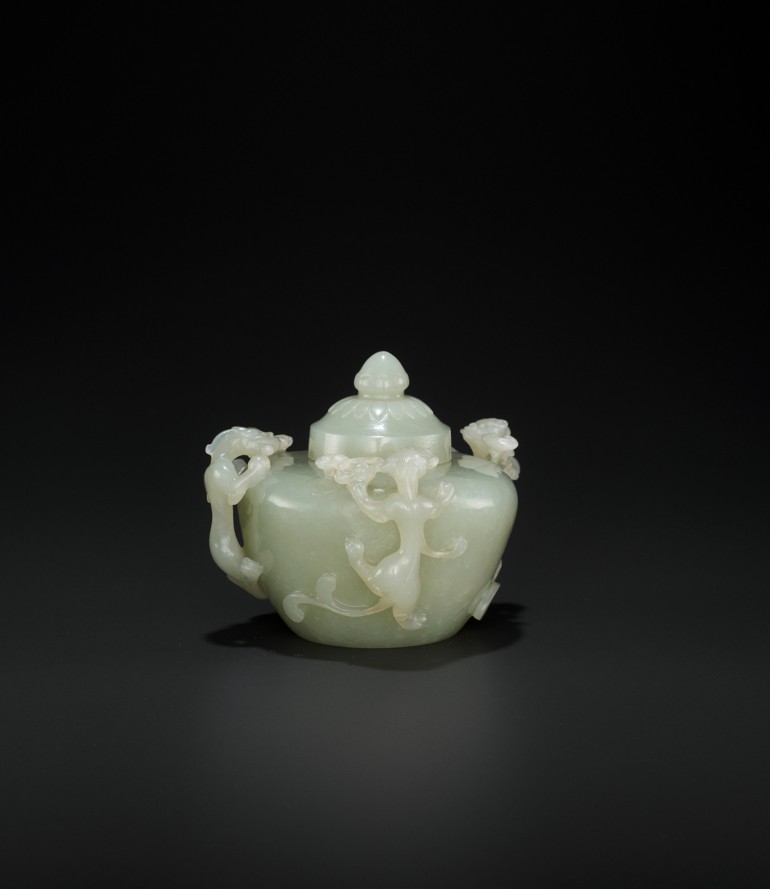 AN OPENWORK PALE CELADON JADE 'CHILONG' WATER POT AND COVER, QING