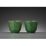 A PAIR OF SPINACH-GREEN JADE CUPS, QING DYNASTY