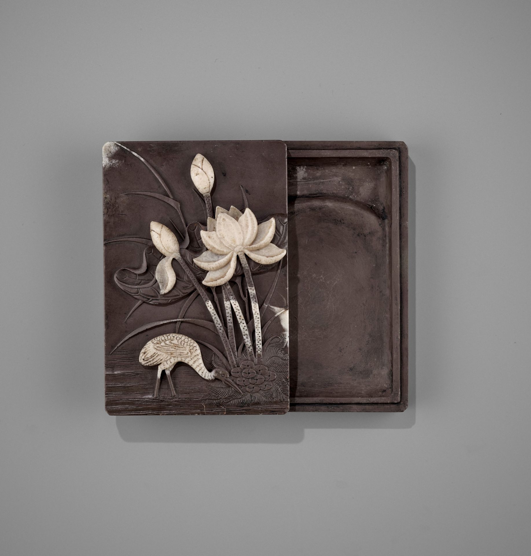 A DUAN 'CRANE AND LOTUS' INKSTONE AND COVER, QING