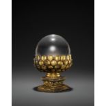 A ROCK CRYSTAL SPHERE WITH A GILT BRONZE LOTUS BASE, QING DYNASTY