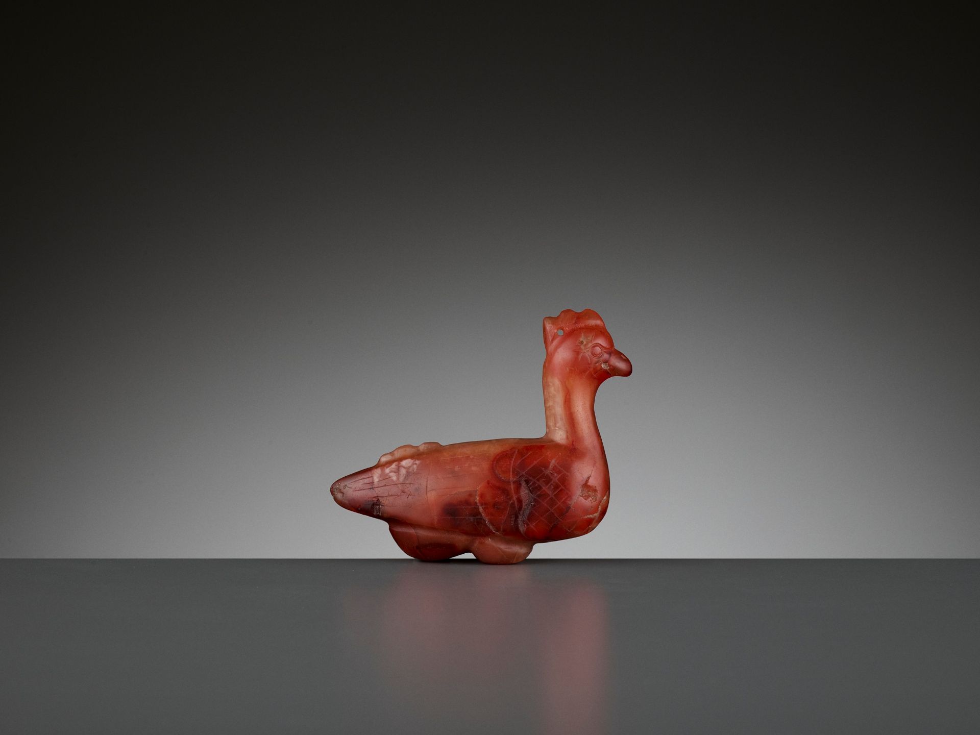 A CARNELIAN 'ROOSTER' PENDANT, 1ST MILLENNIUM AD