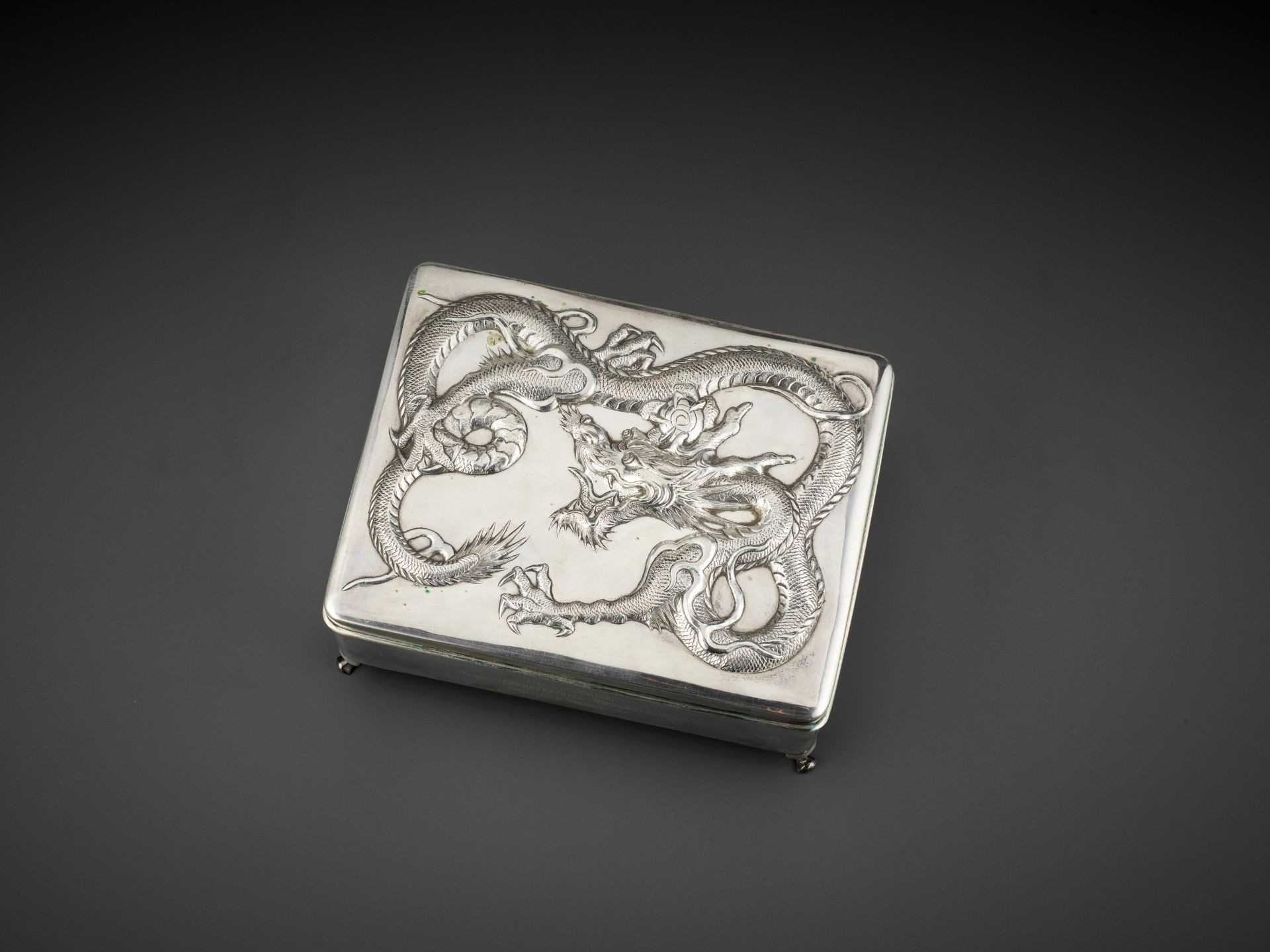 A SILVER REPOUSSE 'DRAGON' BOX AND COVER, WANG HING, LATE QING TO REPUBLIC