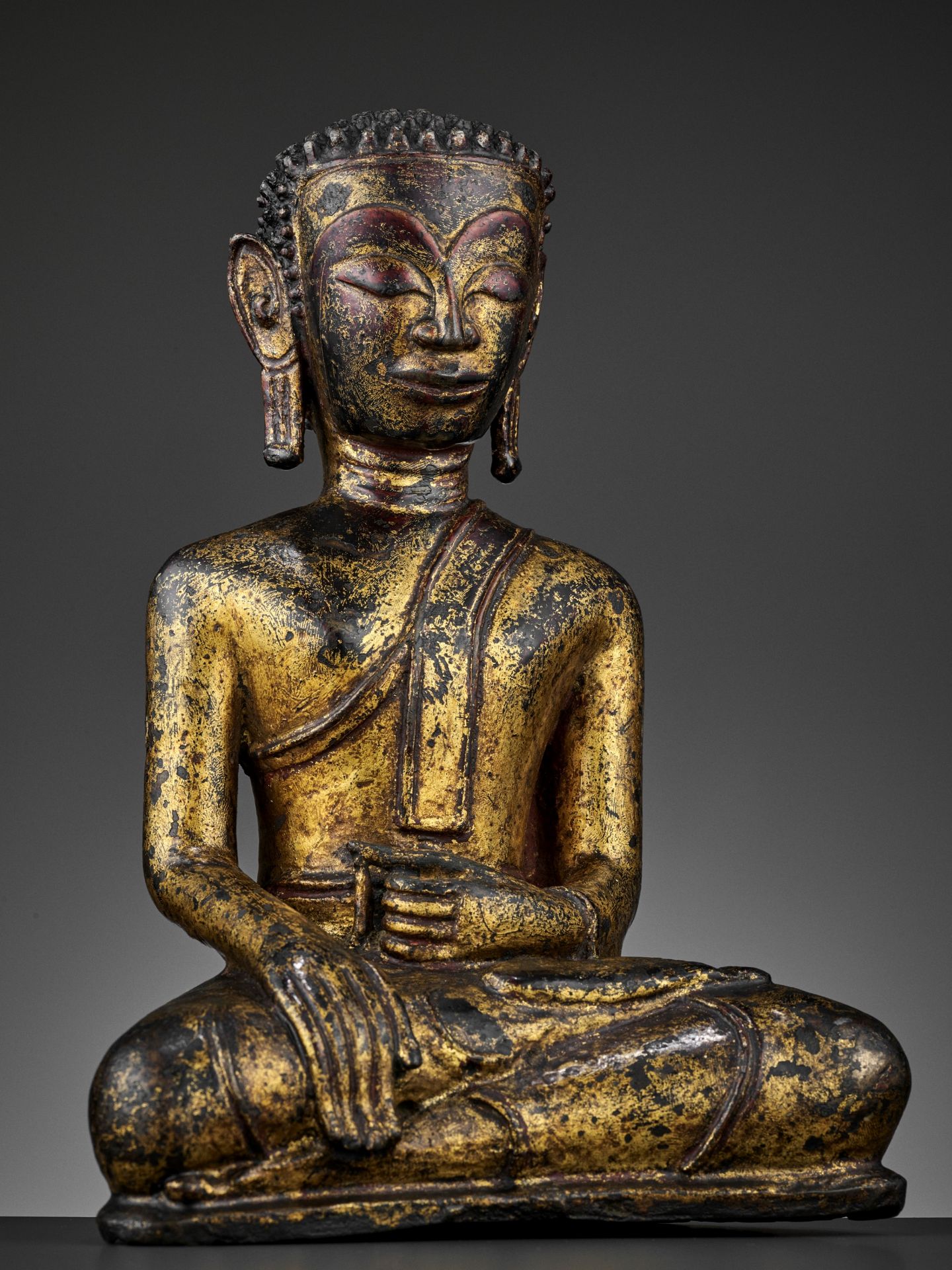 A HEAVILY CAST, GILT-LACQUERED BRONZE OF BUDDHA, 17TH-18TH CENTURY