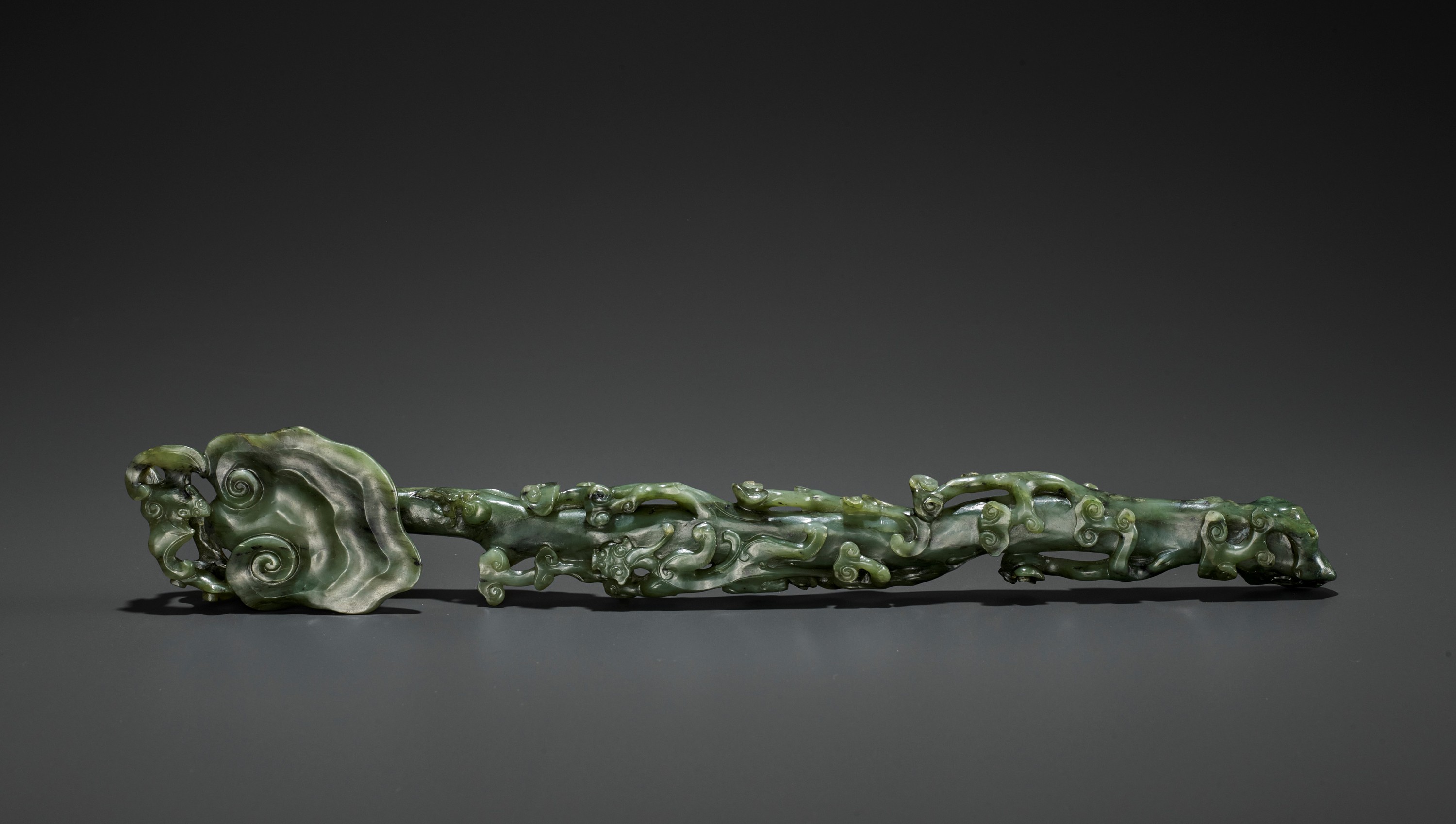 A SPINACH-GREEN JADE RUYI SCEPTER, MID-QING