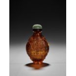 A GOLD-SPLASHED AMBER GLASS 'DOUBLE ELEPHANT' SNUFF BOTTLE, POSSIBLY IMPERIAL, QING DYNASTY