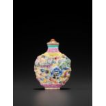 A FAMILLE ROSE MOLDED PORCELAIN 'BUDDHIST LIONS' SNUFF BOTTLE AND MATCHING STOPPER