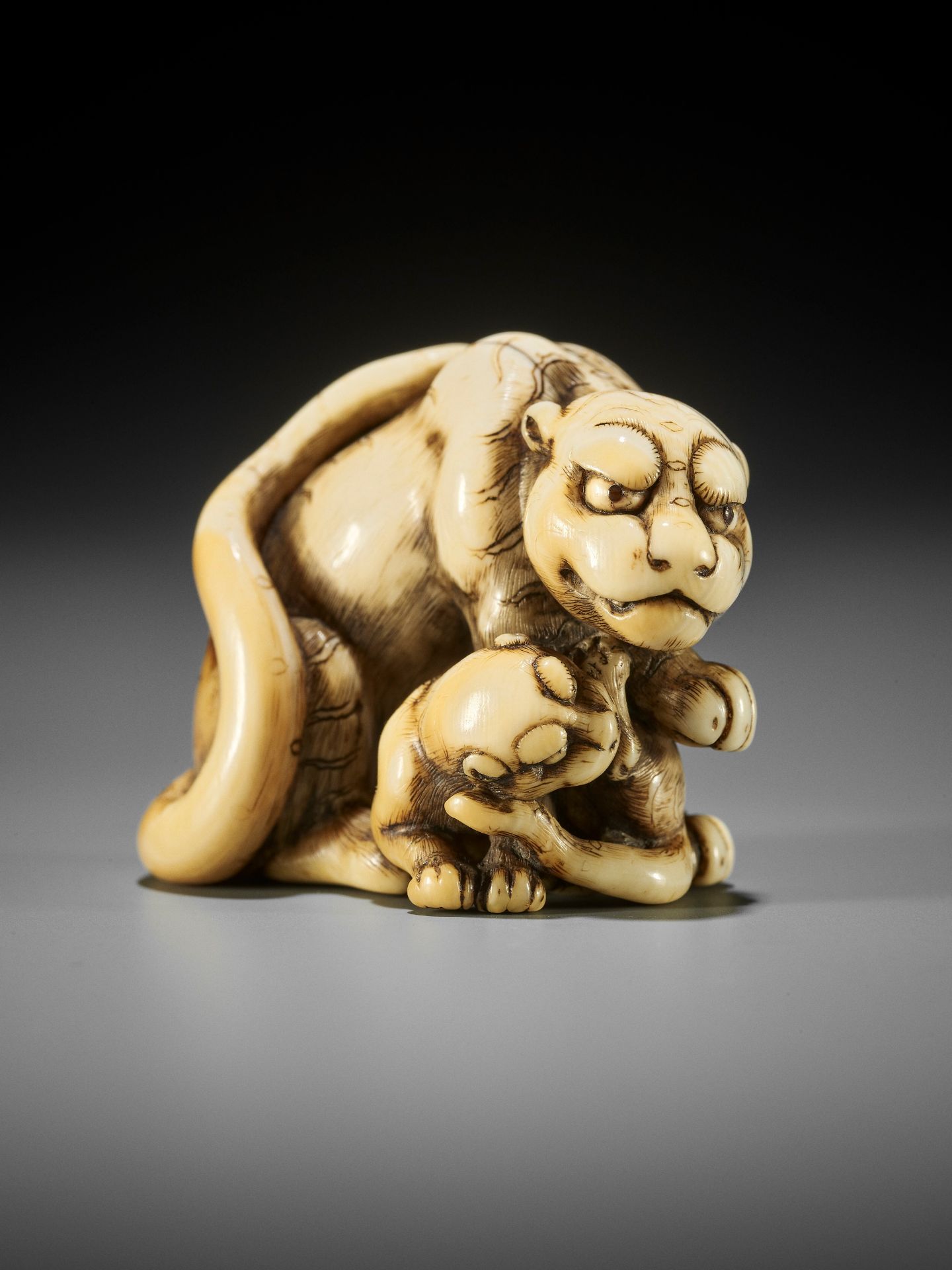 TOMOTADA: AN EXCEPTIONAL IVORY NETSUKE OF A TIGRESS AND CUB - Image 3 of 13