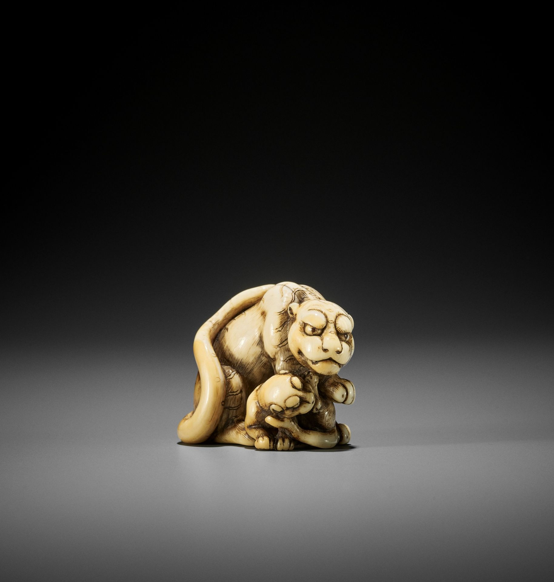 TOMOTADA: AN EXCEPTIONAL IVORY NETSUKE OF A TIGRESS AND CUB