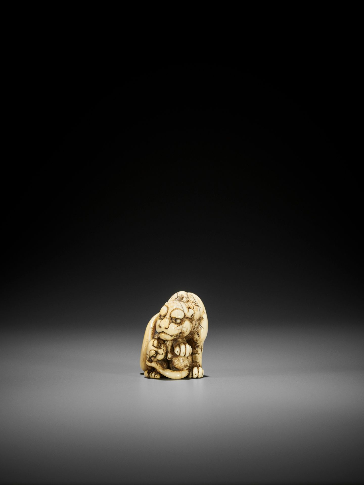 TOMOTADA: AN EXCEPTIONAL IVORY NETSUKE OF A TIGRESS AND CUB - Image 7 of 13