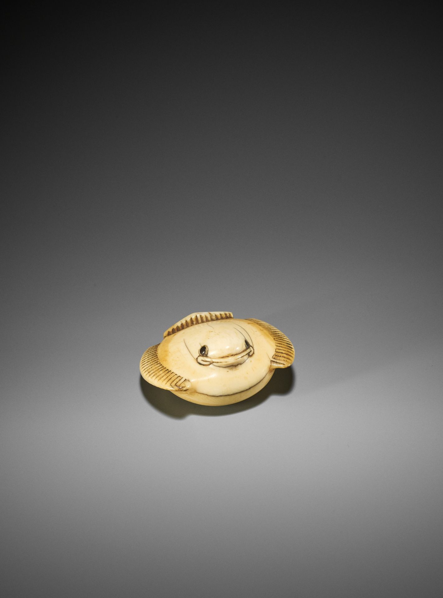 GYOKUSEN: AN IVORY NETSUKE OF THE FUKURA SUZUME (PUFFED-UP SPARROW)