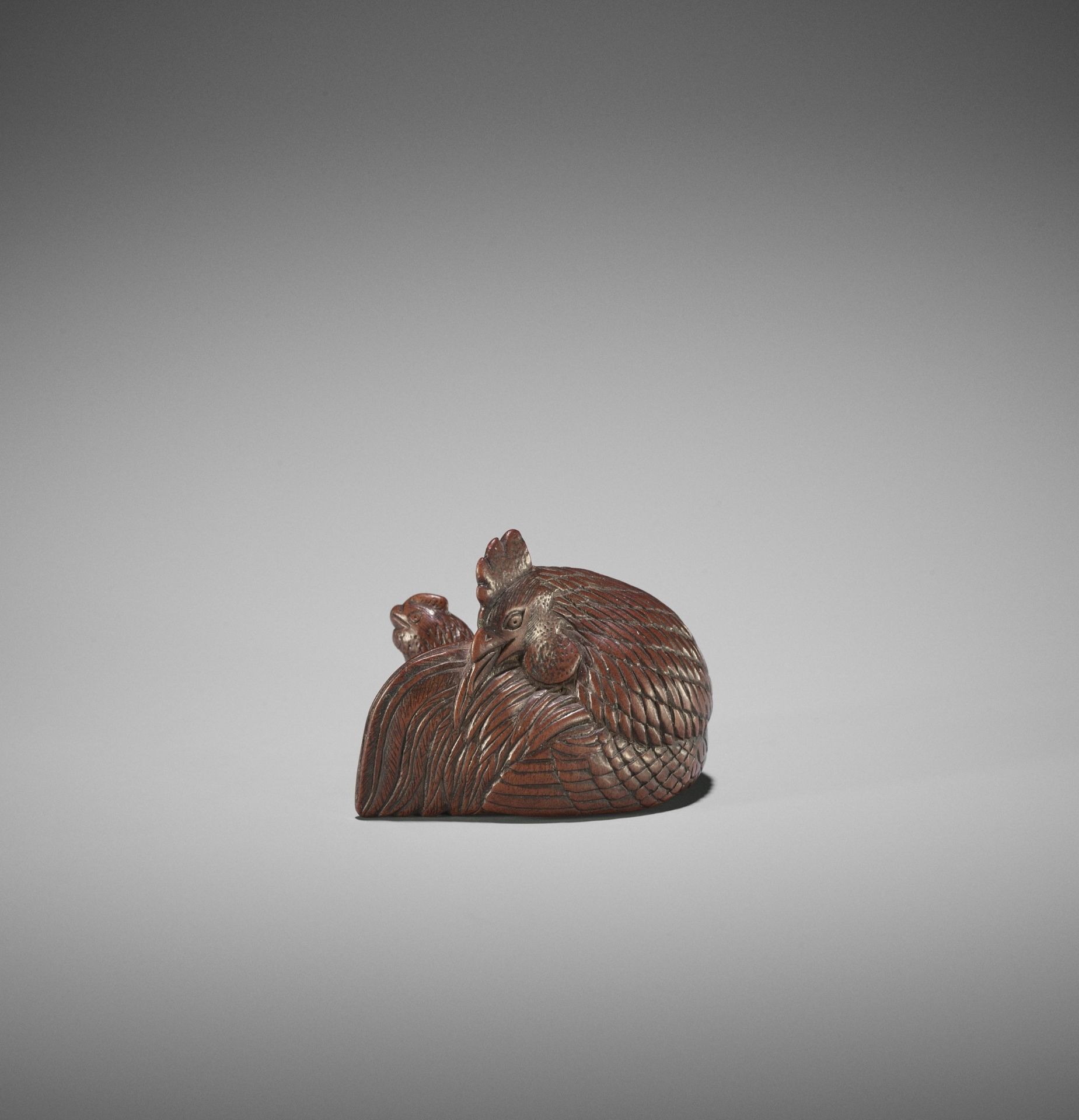 A SUPERB WOOD NETSUKE OF A COCKEREL AND HEN