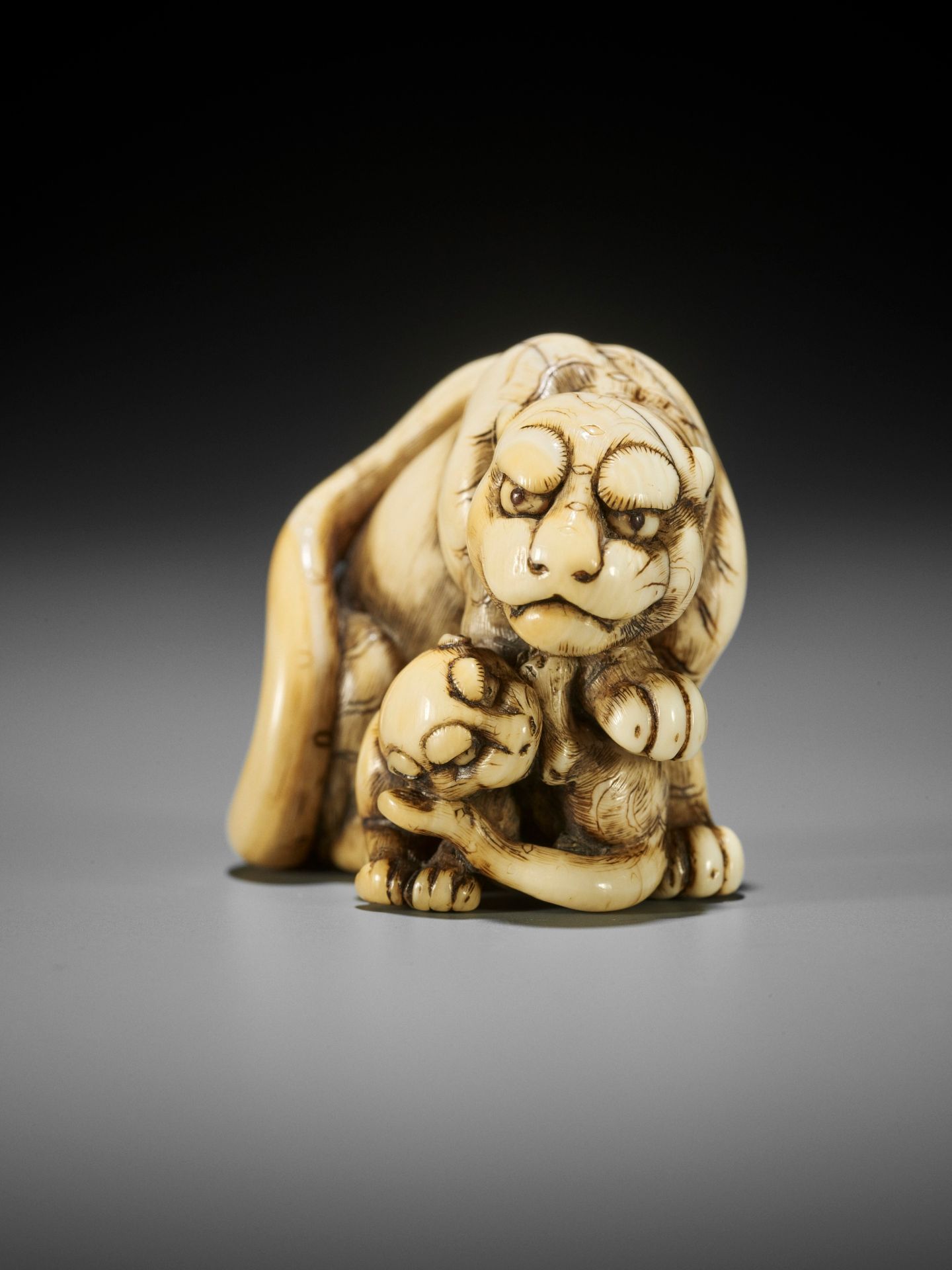 TOMOTADA: AN EXCEPTIONAL IVORY NETSUKE OF A TIGRESS AND CUB - Image 2 of 13