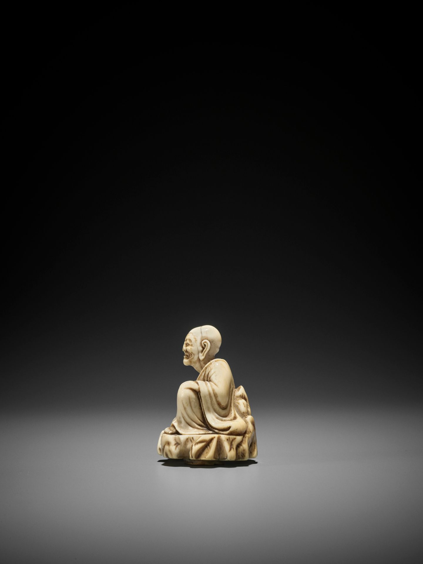 AN UNUSUAL AND EARLY TOBORI STYLE IVORY NETSUKE OF A RAKAN ON A ROCK - Image 4 of 10