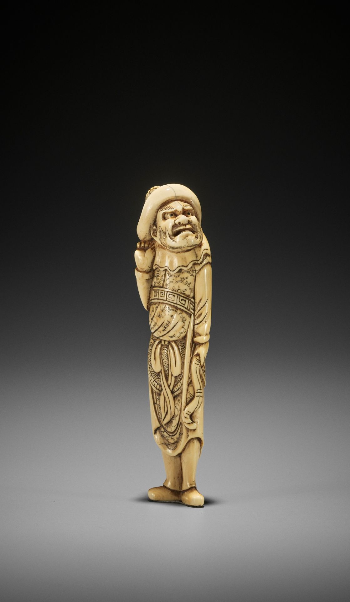 A TALL IVORY NETSUKE OF A TARTAR ARCHER