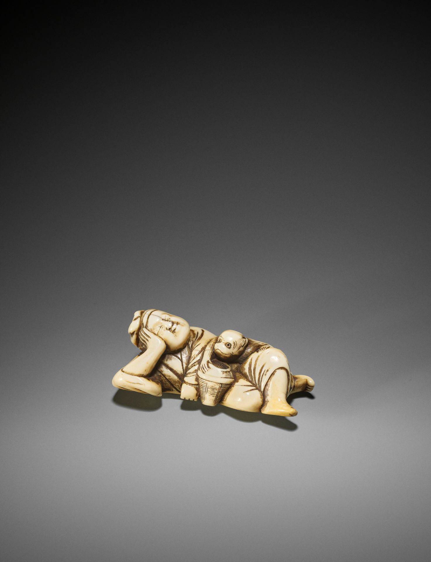 A GOOD IVORY NETSUKE OF A SLEEPING SARUMAWASHI AND THIEVING MONKEY