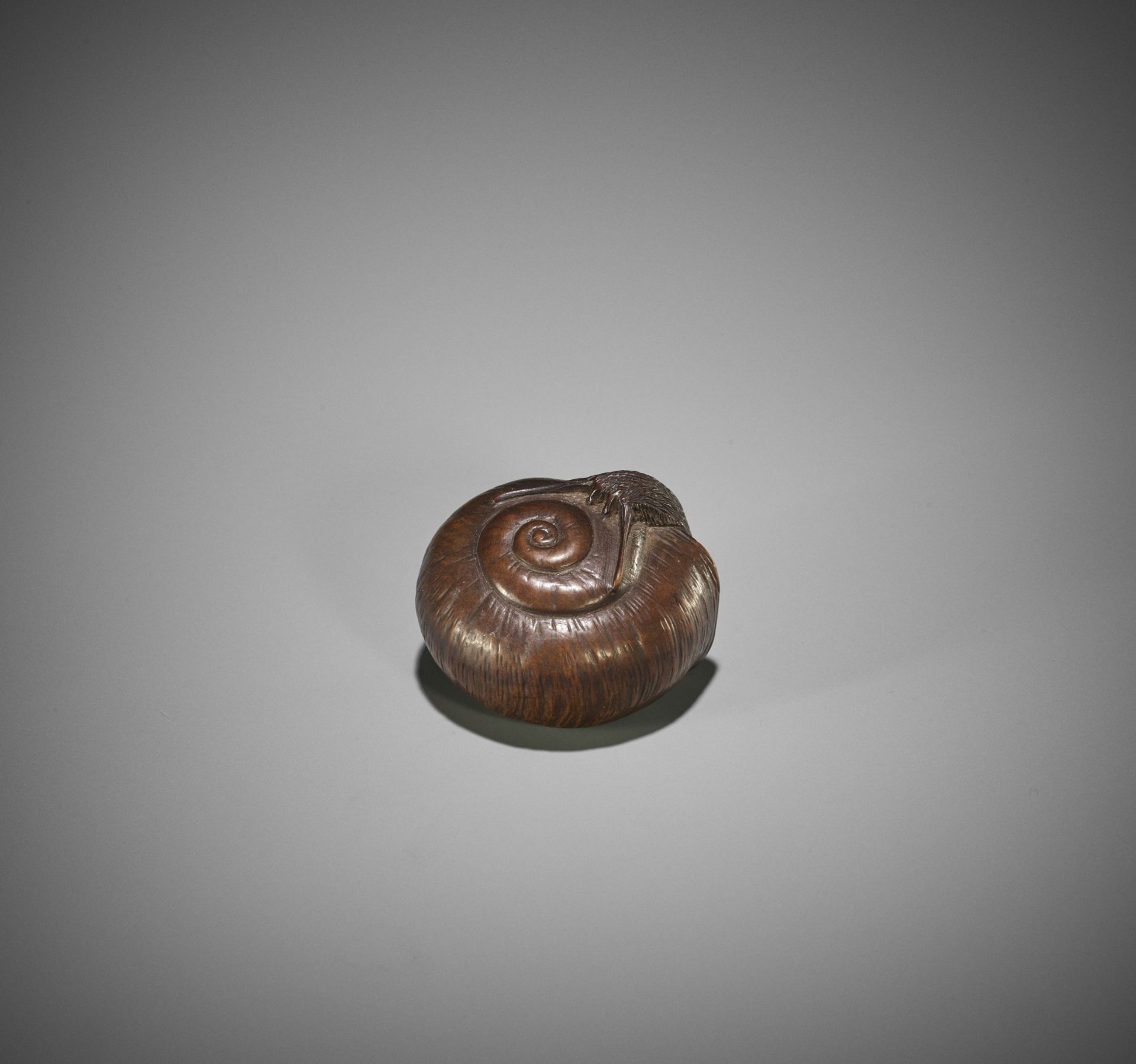 A NAGOYA SCHOOL WOOD NETSUKE OF A SNAIL