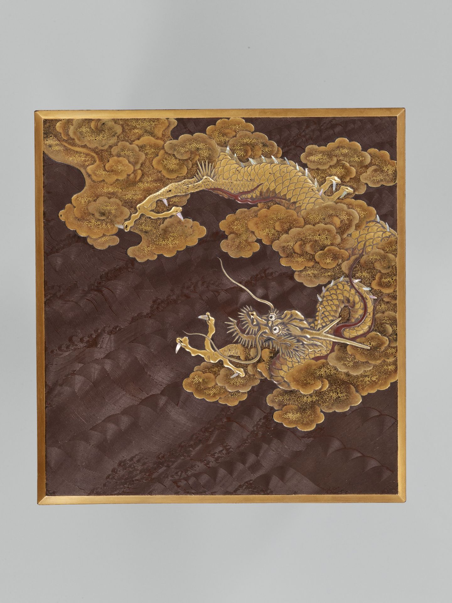 A SUPERB ZESHIN-STYLE INLAID LACQUER SUZURIBAKO WITH DRAGON AMONGST CLOUDS AND COMBED WAVES