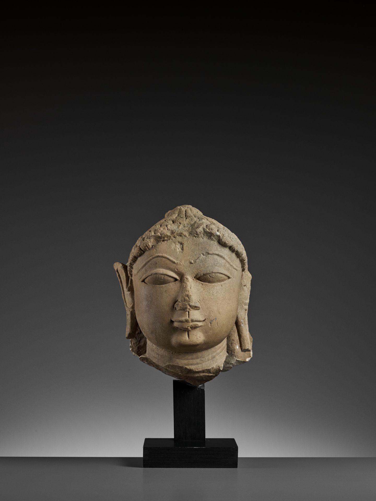 A JAIN SANDSTONE HEAD OF A JINA