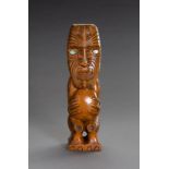 A CARVED MAORI TIKI WOOD FIGURE