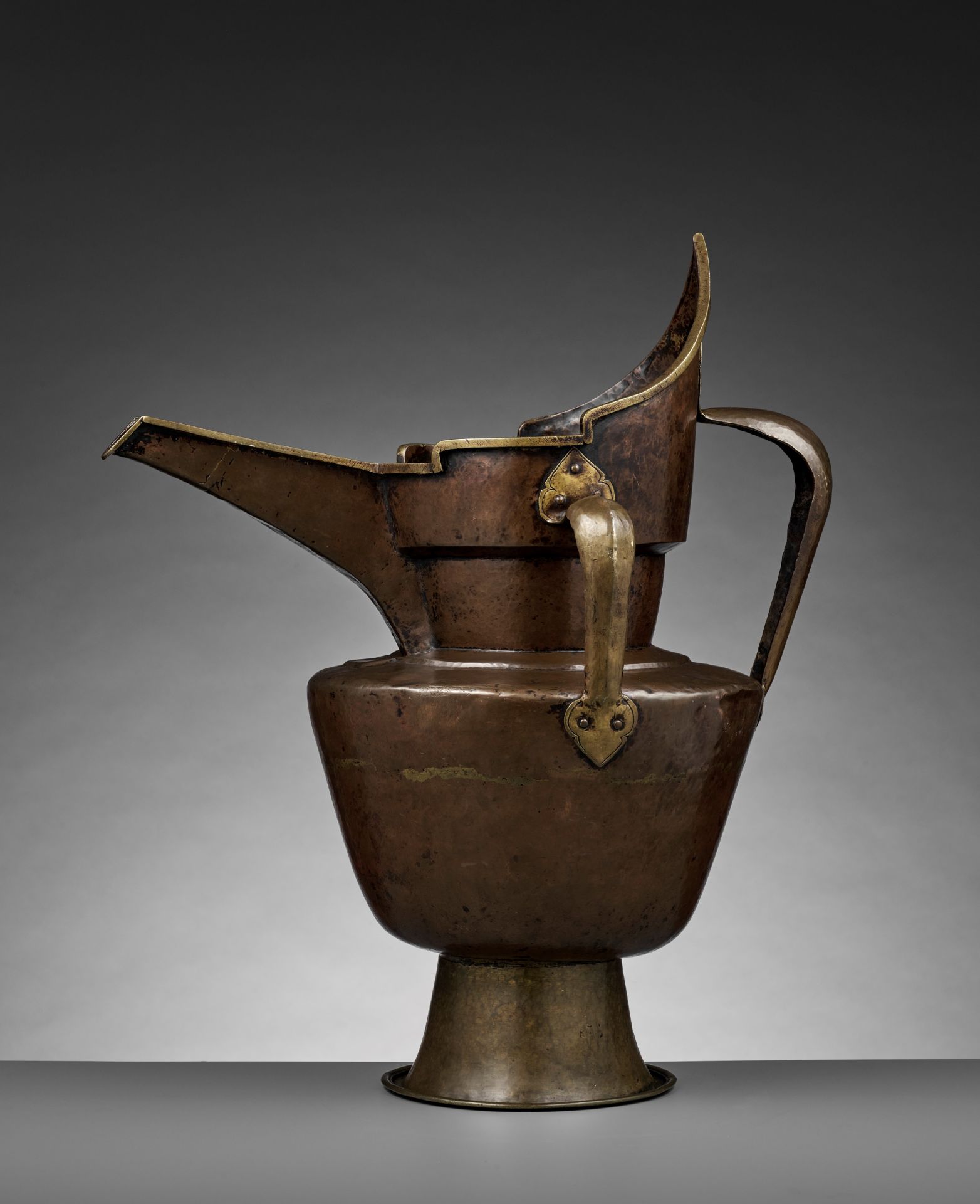 A TIBETAN-CHINESE PARCEL-GILT BRONZE 'MONK'S CAP' EWER, SENGMAOHU