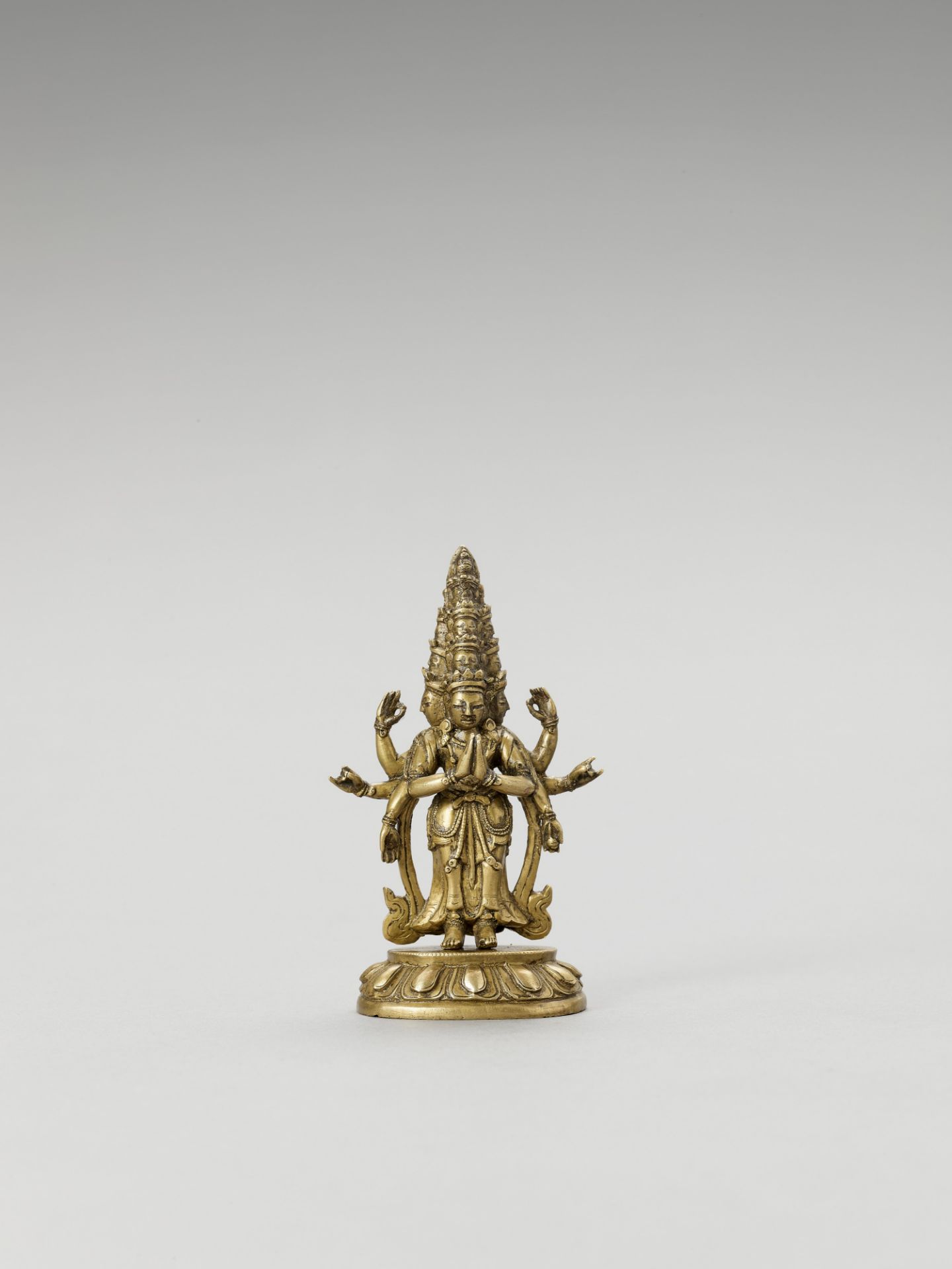 A SINO-TIBETAN GILT BRONZE FIGURE OF EKADASHAMUKHA AVALOKITESVARA, QING