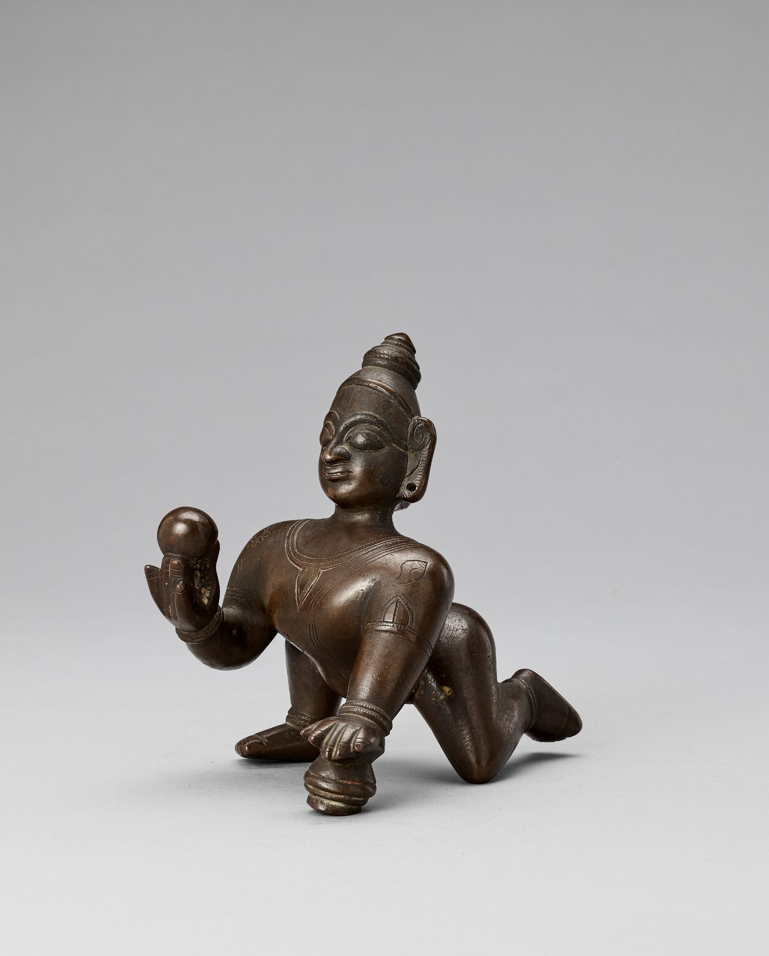 A HEAVILY CAST BRONZE FIGURE OF BALAKRISHNA, 18TH-19TH CENTURY