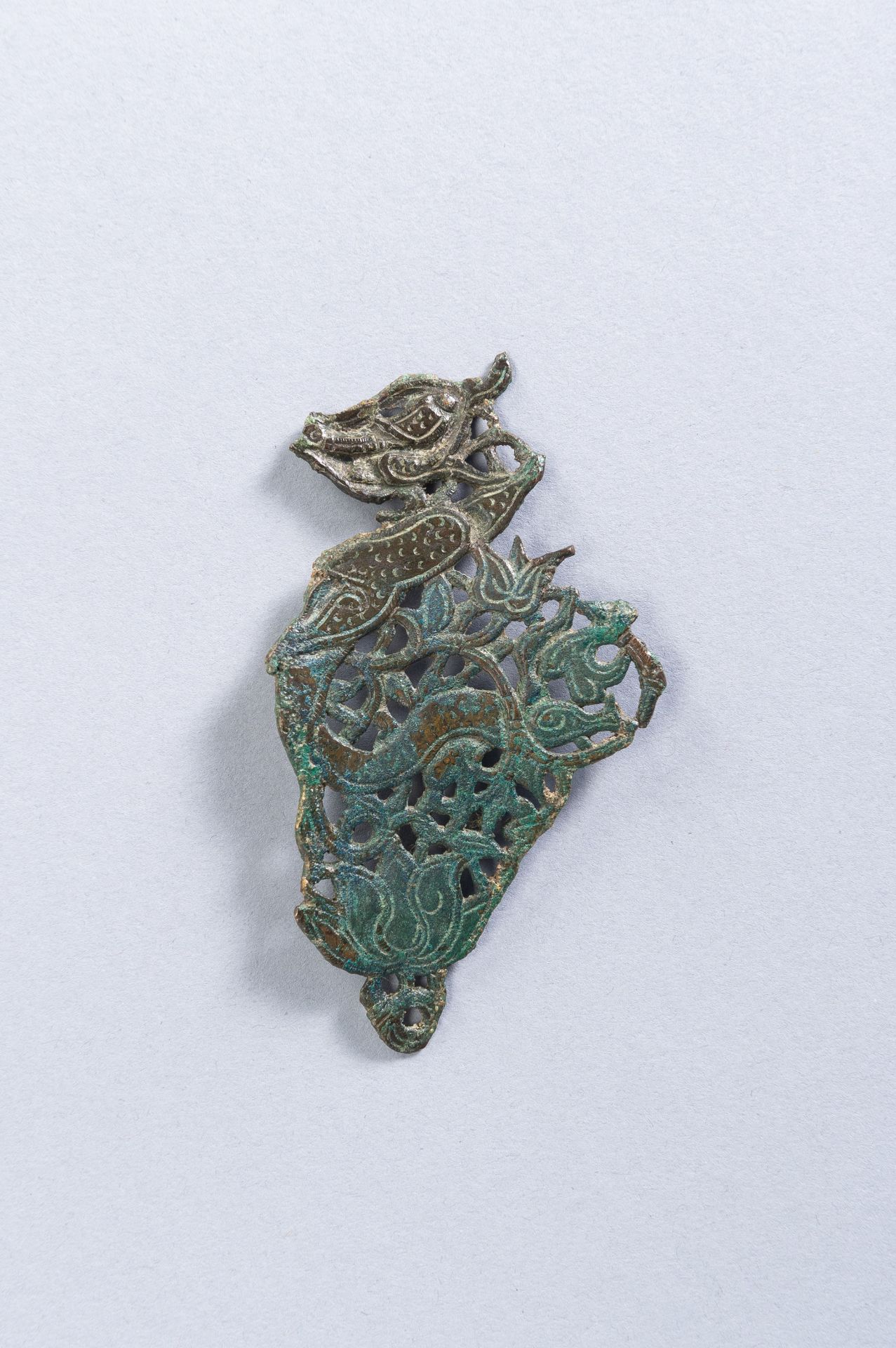 A CHINESE BRONZE ORNAMENT, TANG TO LIAO