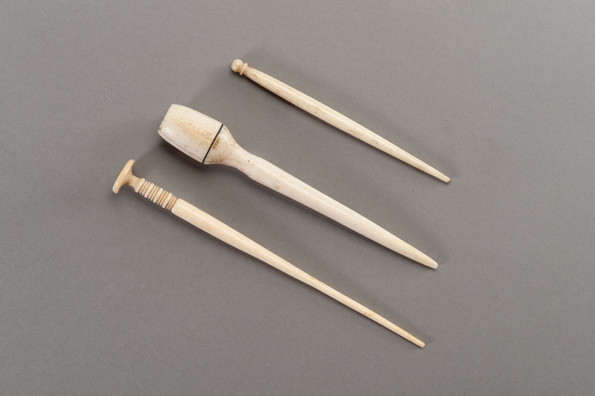 A GROUP OF THREE IVORY HAIRPINS