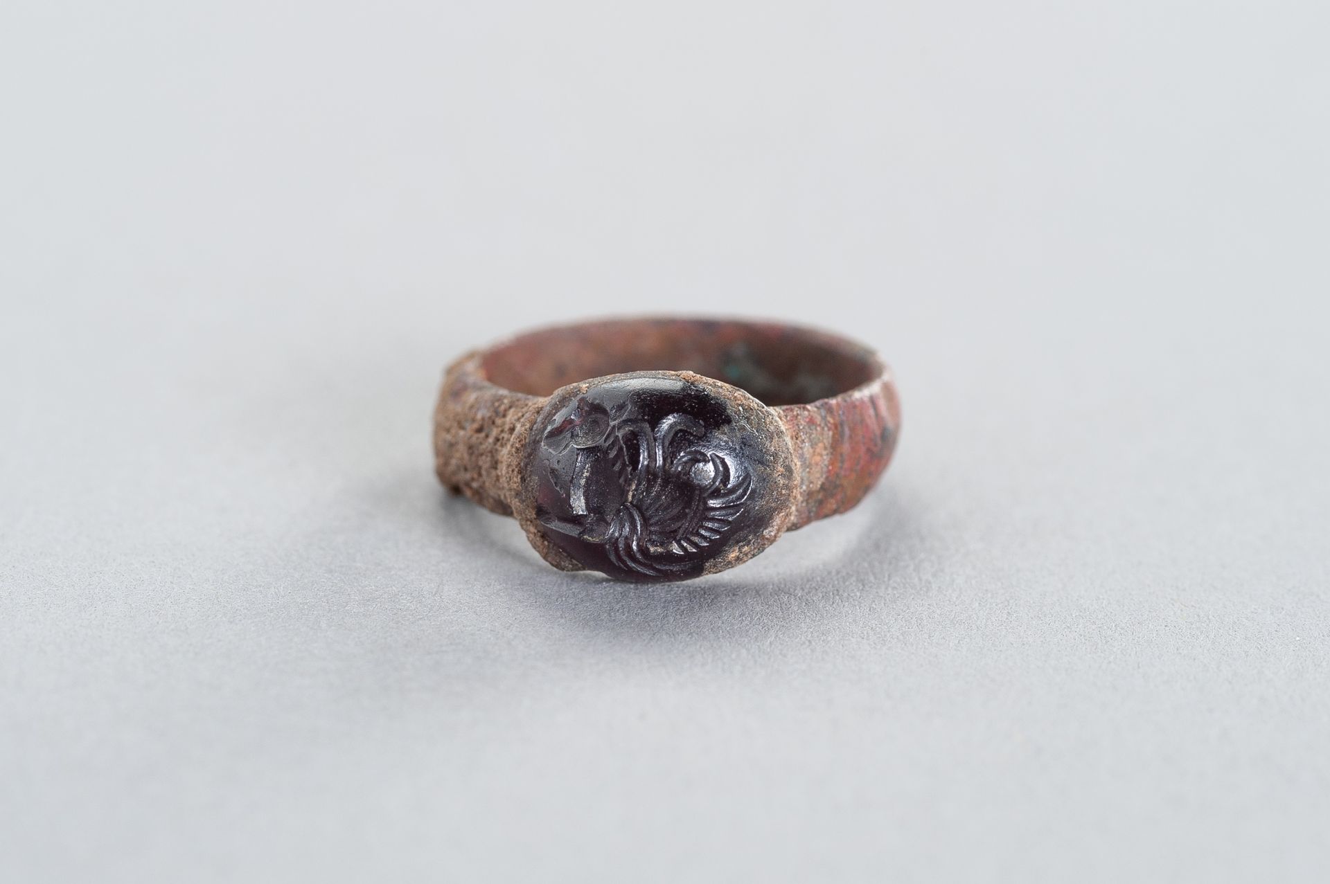 AN ANCIENT COPPER RING WITH AN INTAGLIO