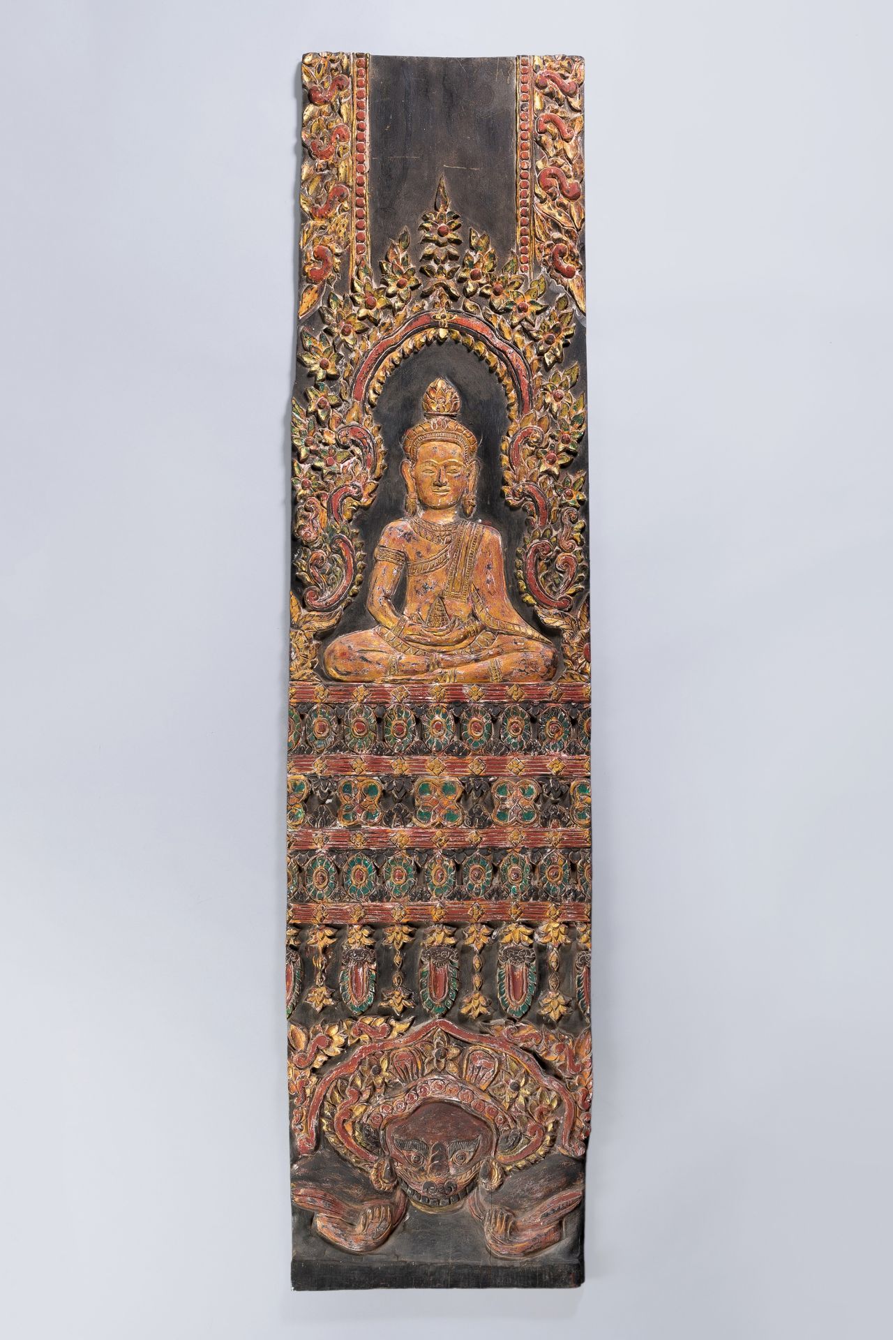 A LARGE CARVED WOOD PANEL DEPICTING BUDDHA