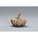 A CARVED STONE DEPICTING A PUMPKIN