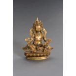 A TIBETAN GILT BRONZE FIGURE OF JAMBHALA