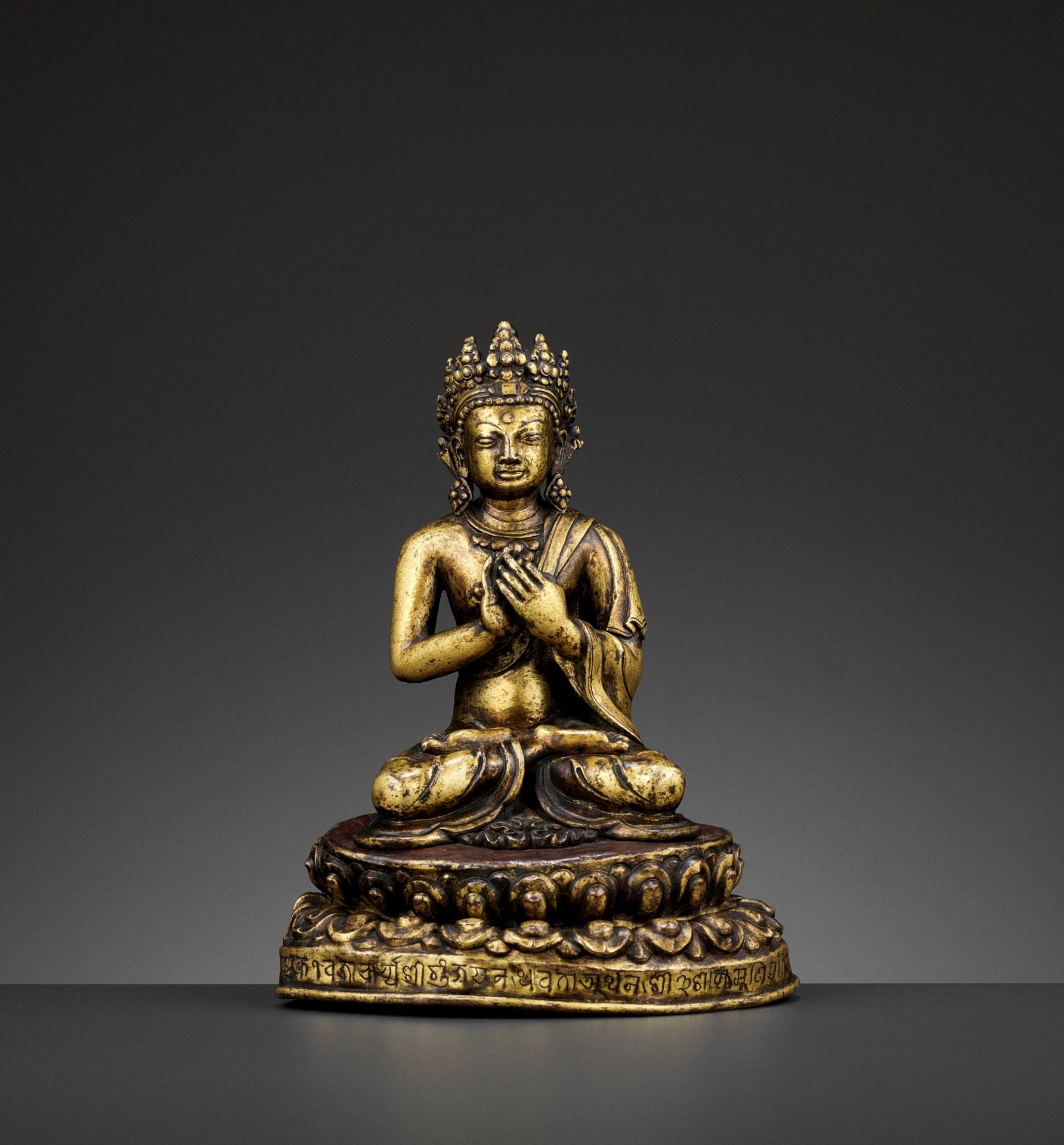 A GILT BRONZE FIGURE OF A CROWNED BUDDHA, DATED 1709