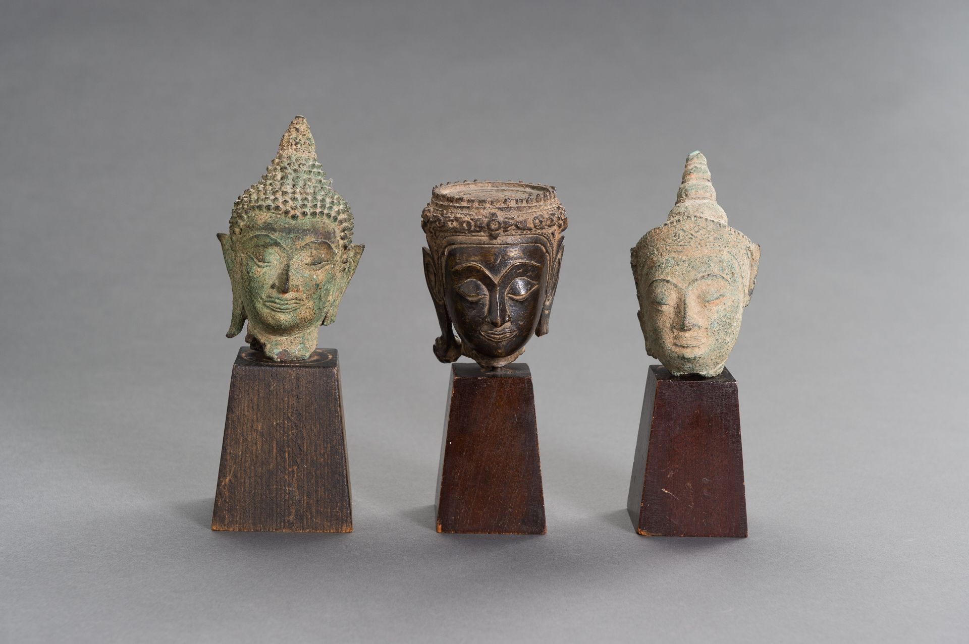 A LOT WITH THREE BRONZE BUDDHA HEADS
