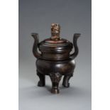 A HEAVILY CAST BRONZE TRIPOD CENSER