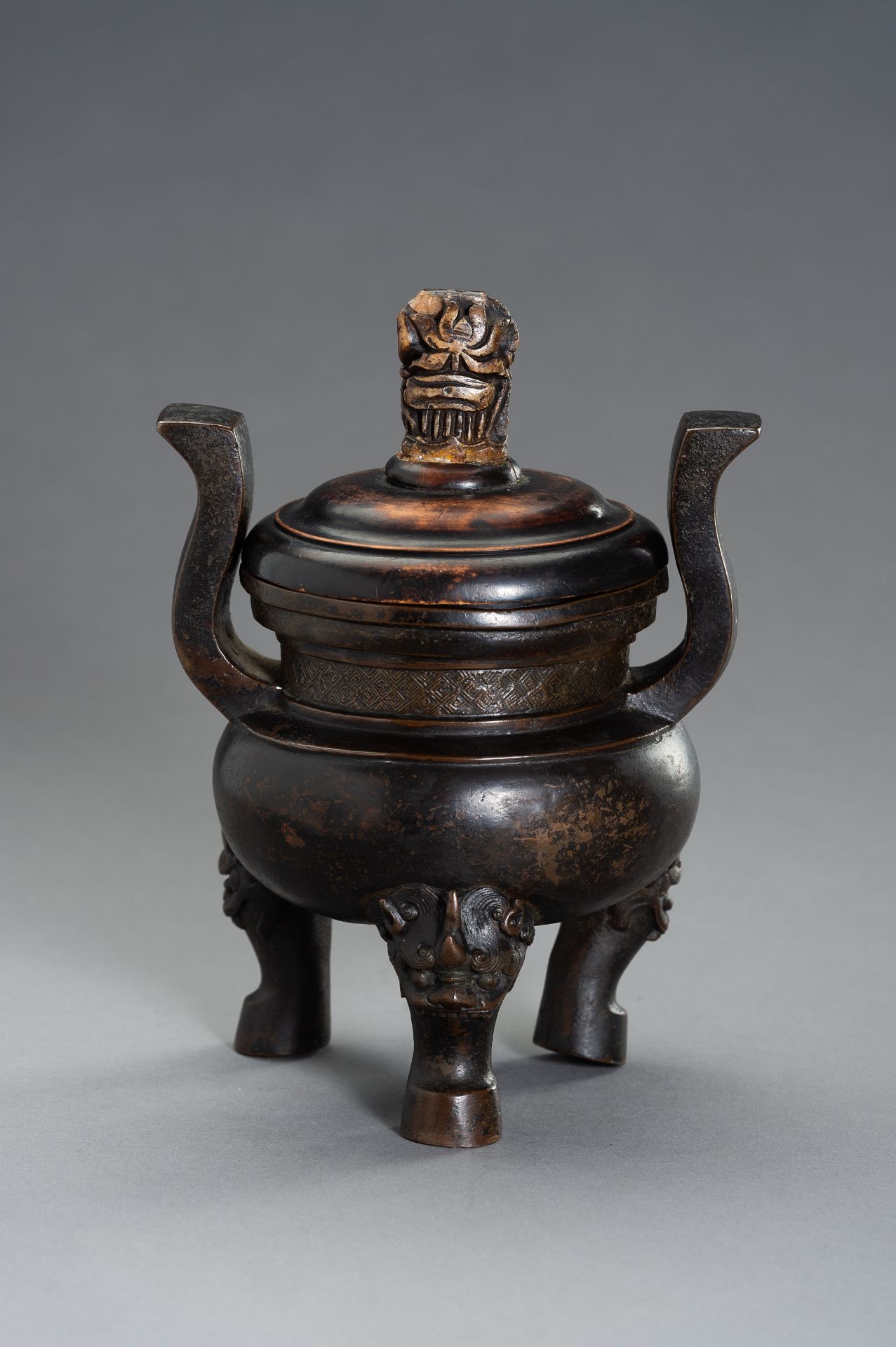 A HEAVILY CAST BRONZE TRIPOD CENSER