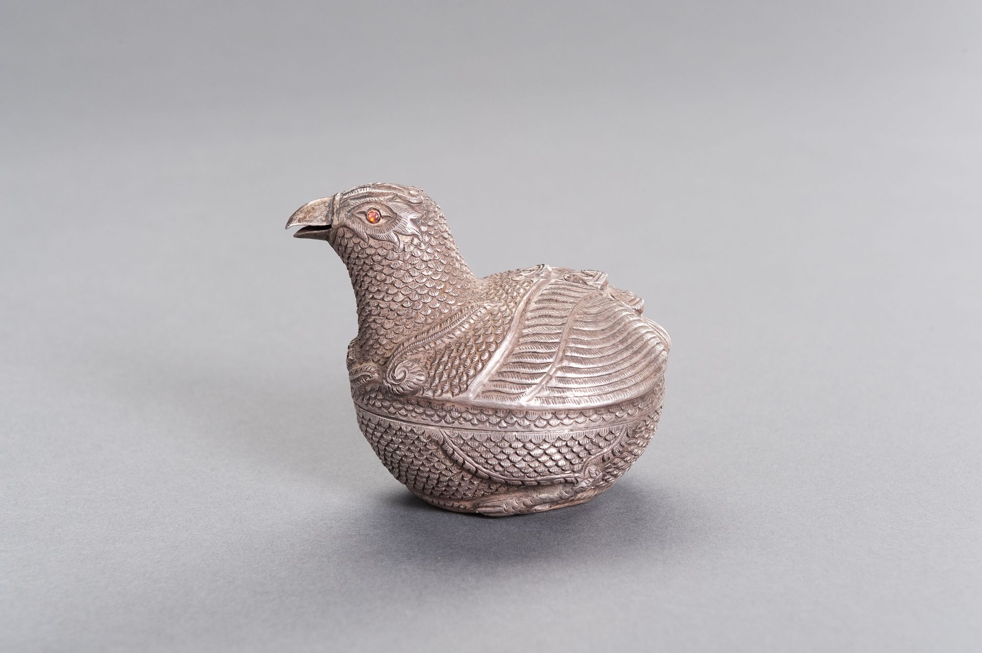 A SILVER MEDICINE BOX SHAPED AS A BIRD