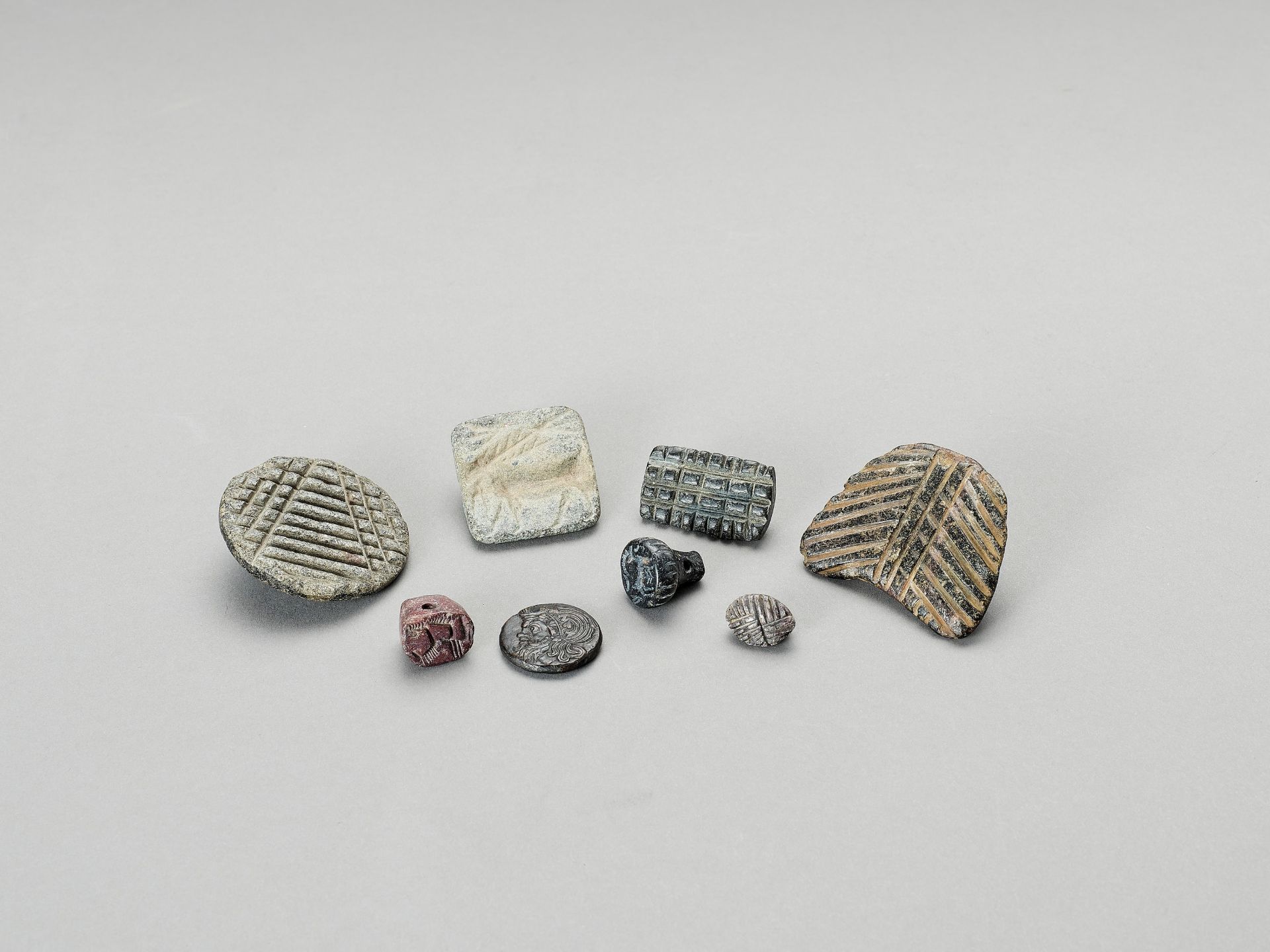 A MIXED LOT OF SEVEN NEAR EAST STONE SEALS AND A BRONZE PANTICAPAEUM COIN