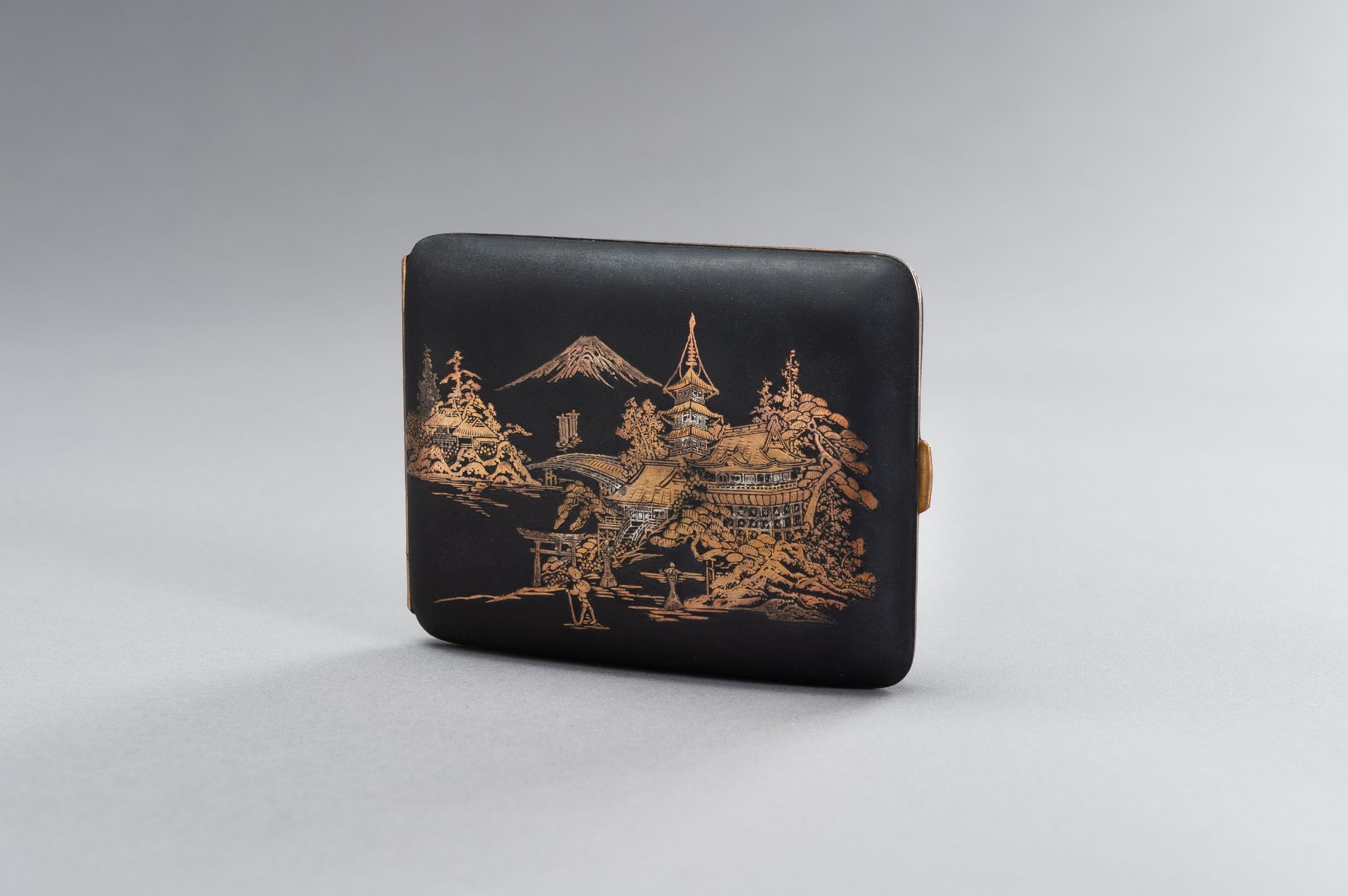 AN IRON KOMAI STYLE CIGARETTE CASE DEPICTING MOUNT FUJI