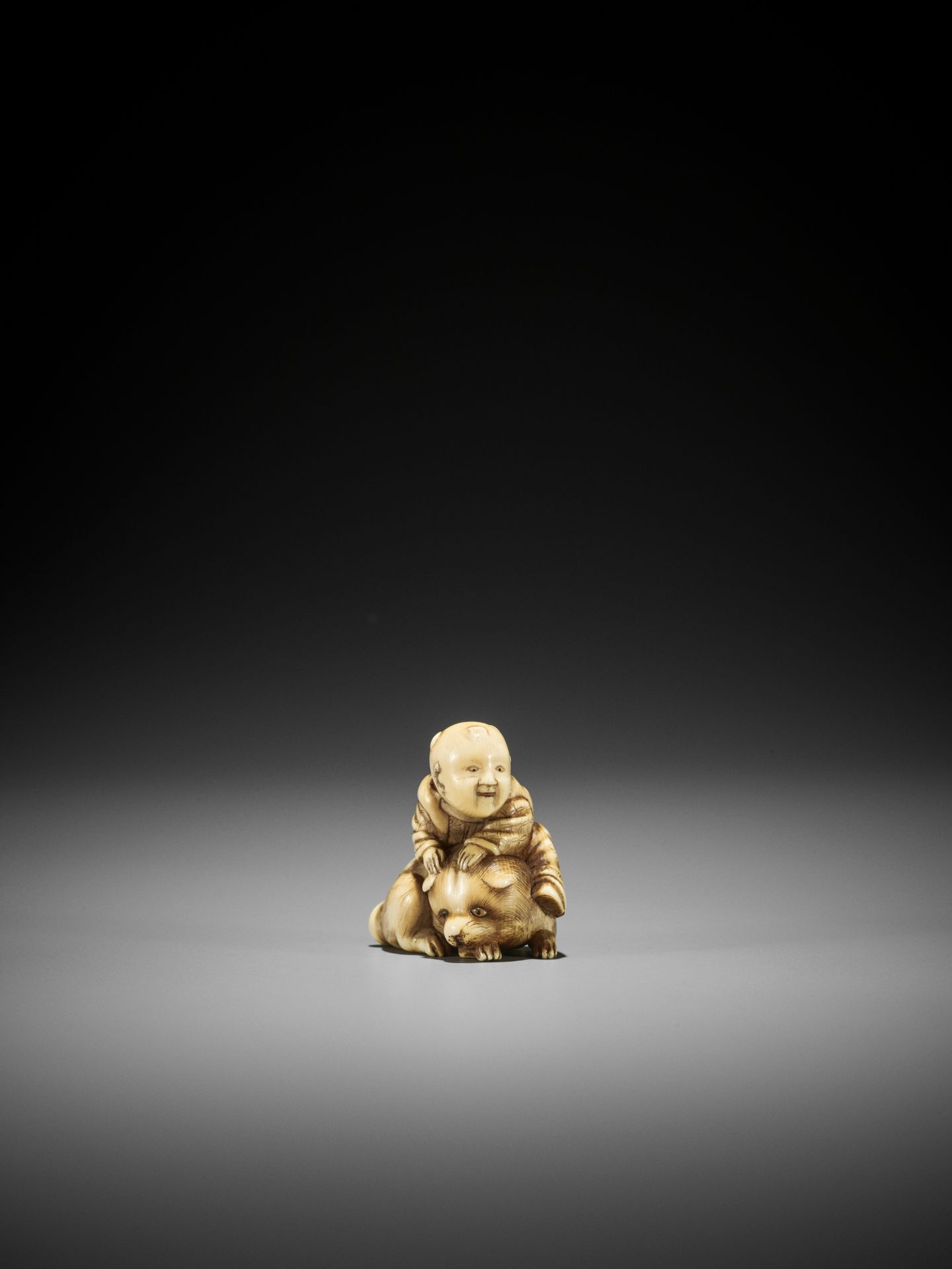 AN OSAKA SCHOOL IVORY NETSUKE OF A KARAKO ON A PUPPY - Image 2 of 3