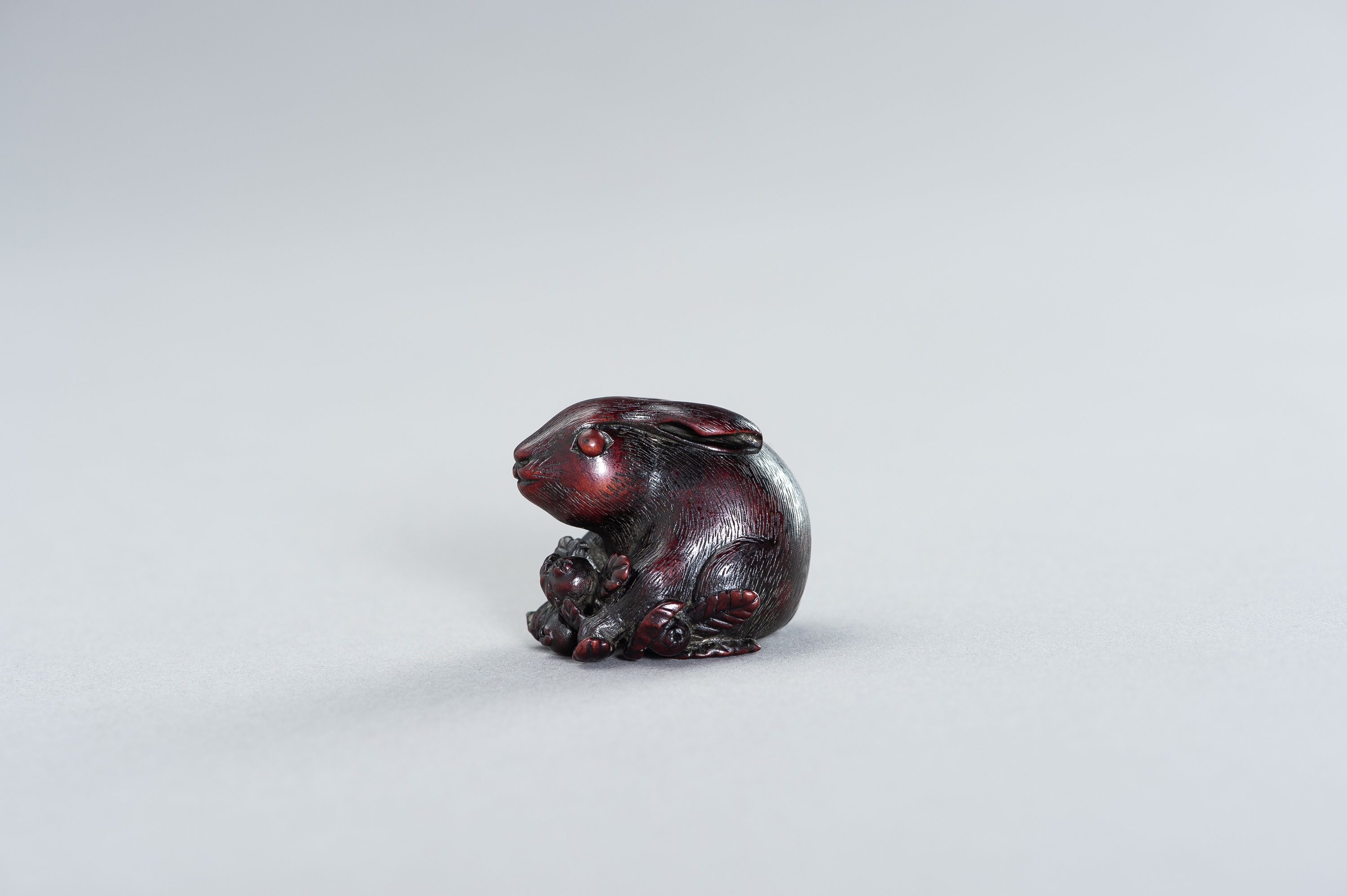 A WOOD NETSUKE OF A HARE WITH BIWA FRUIT - Image 2 of 2