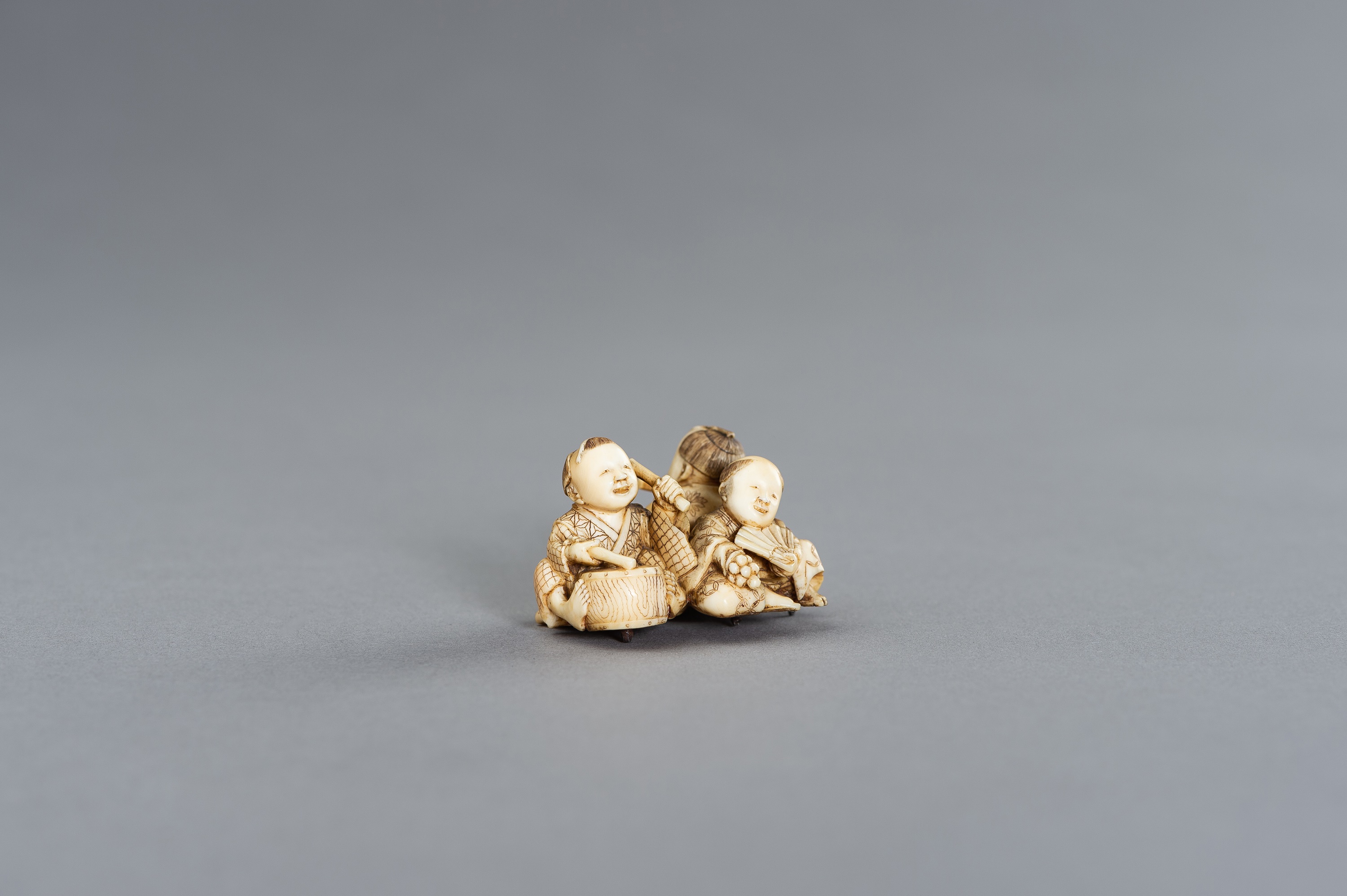 AN IVORY NETSUKE OKIMONO OF THREE BOYS AS MUSICIANS - Image 2 of 11