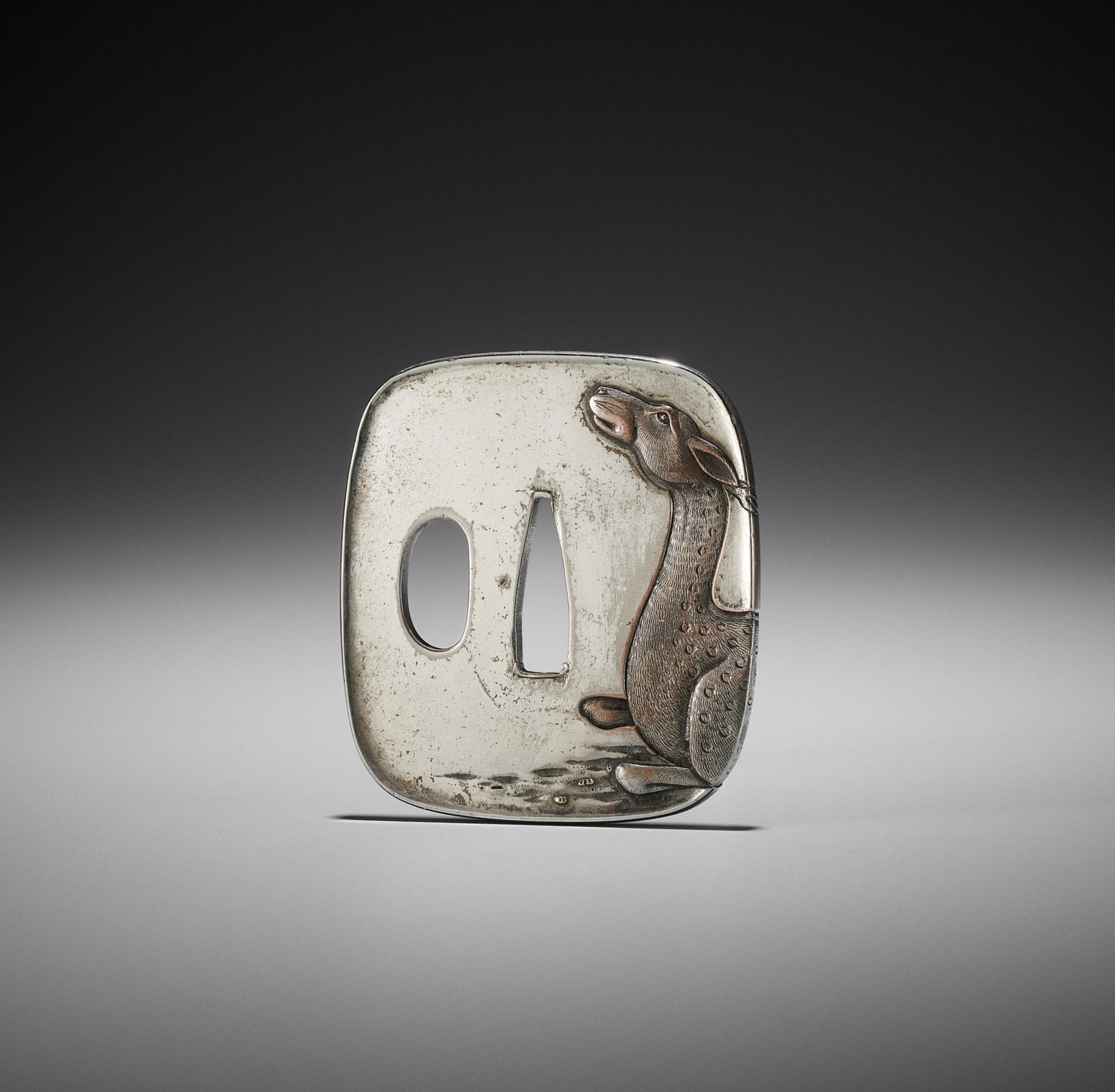 A SILVERED TSUBA WITH A RECUMBENT DEER