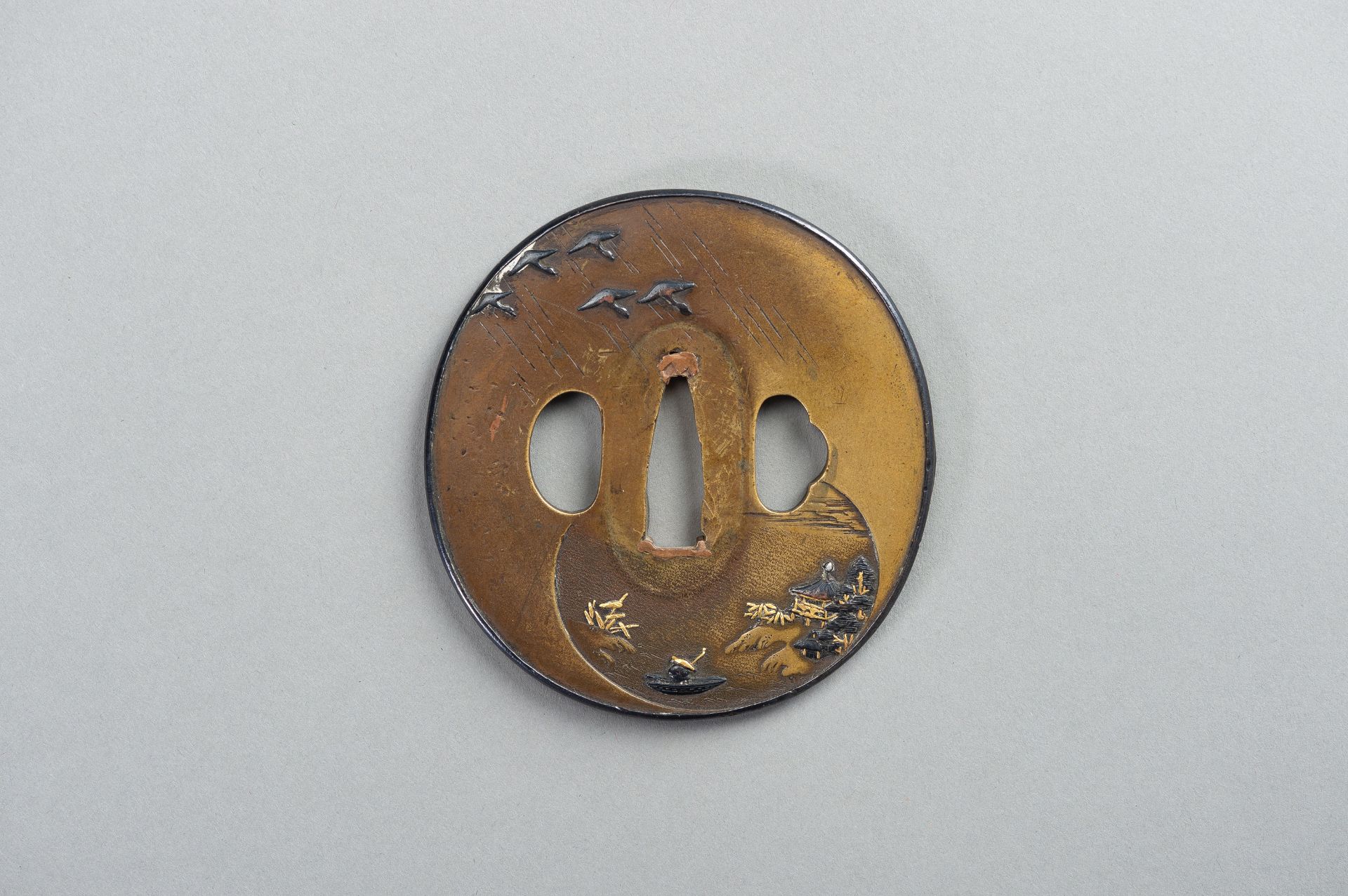 A SENTOKU TSUBA WITH A LANDSCAPE