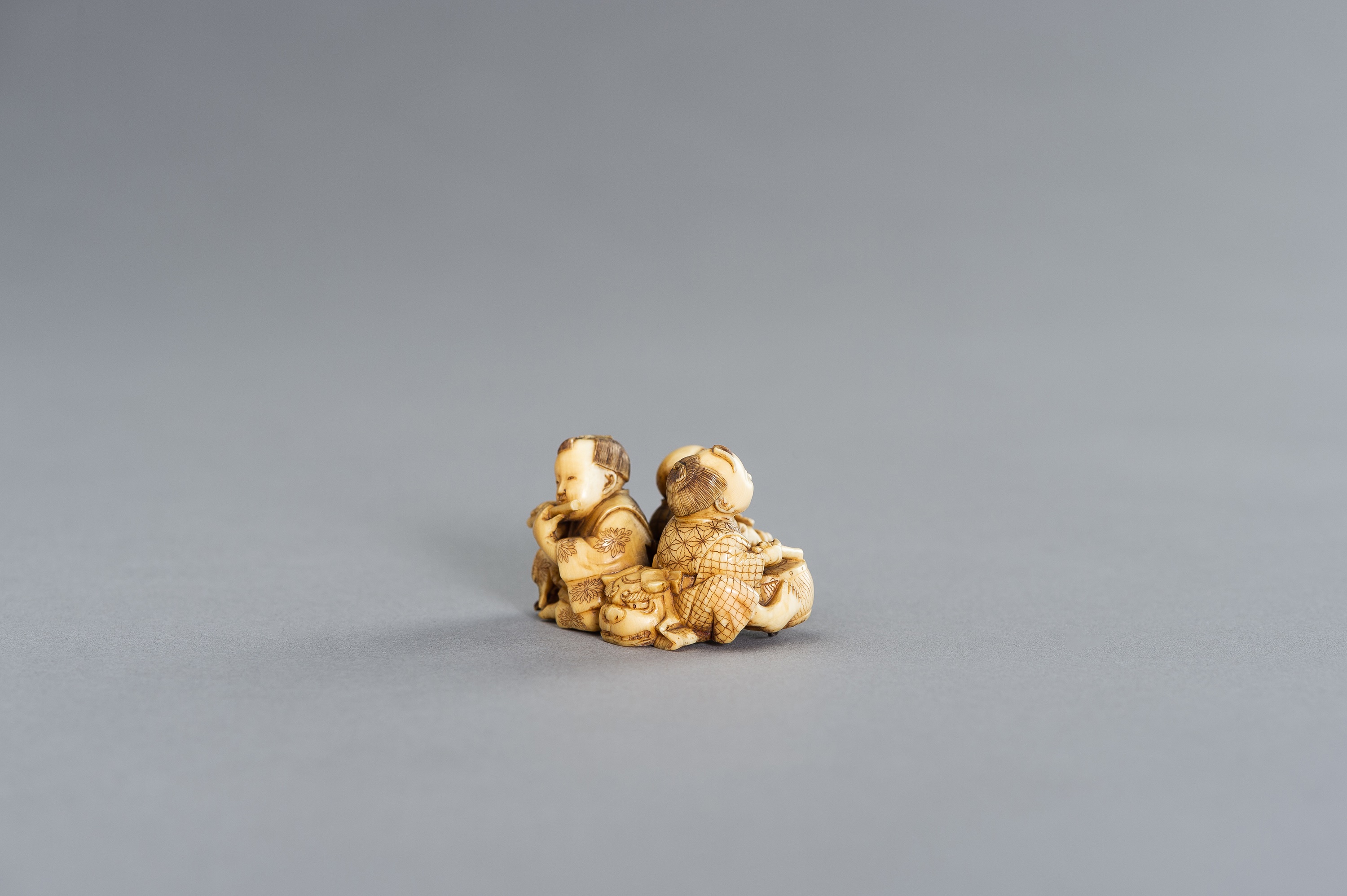 AN IVORY NETSUKE OKIMONO OF THREE BOYS AS MUSICIANS - Image 9 of 11